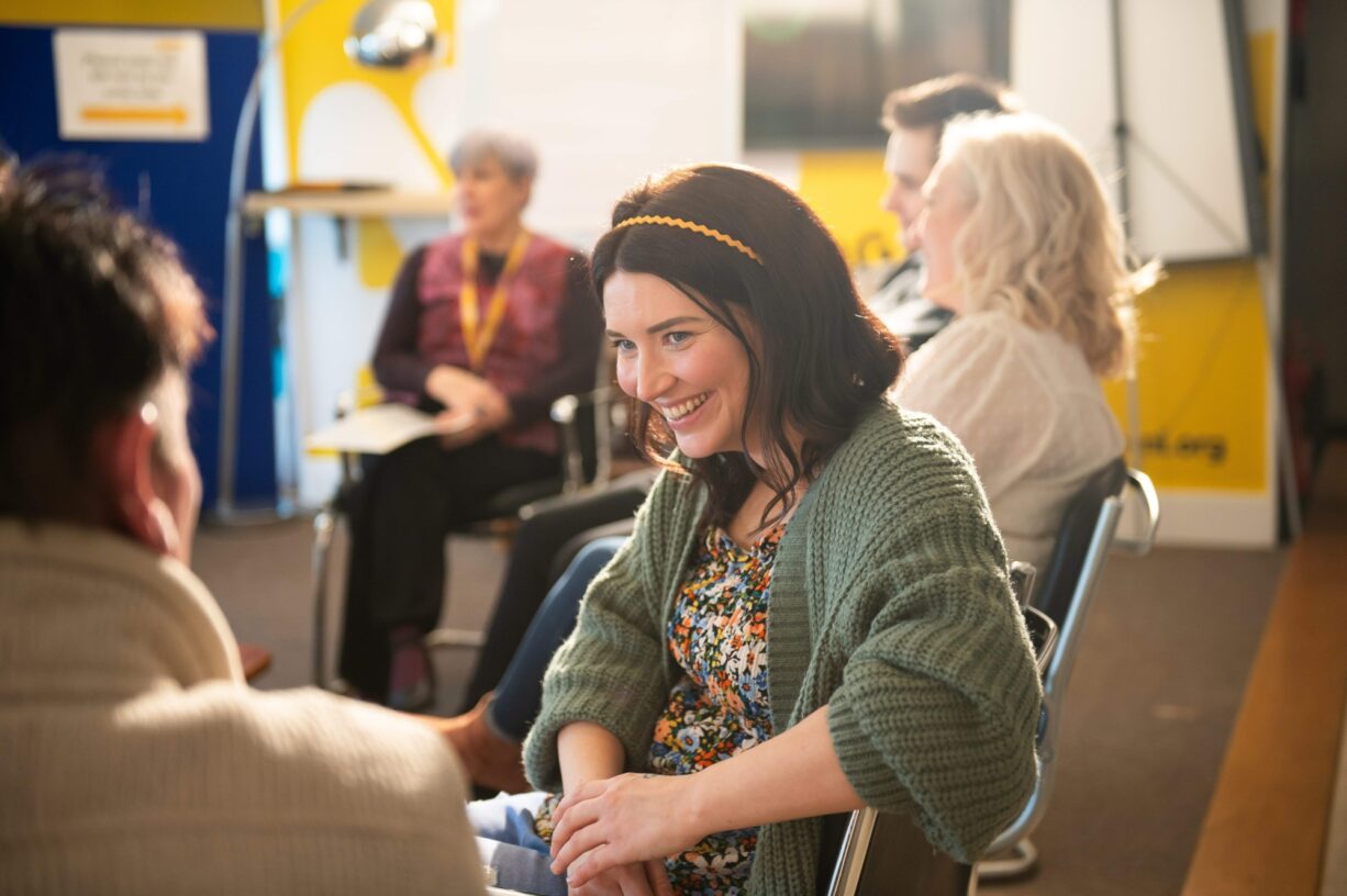 Woman-smiling-during-an-AWARE-NI-mental-health-support-group