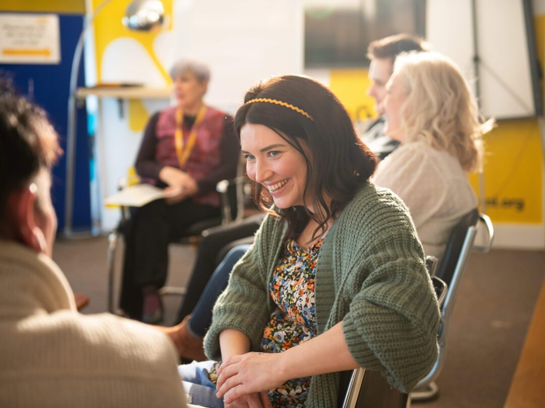 Woman-smiling-during-an-AWARE-NI-mental-health-support-group